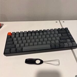 Compact Gray Mechanical Keyboard with Orange Accent